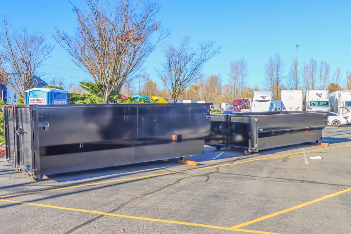 Professional dumpster rental service with roll-off container on residential driveway in Longswamp